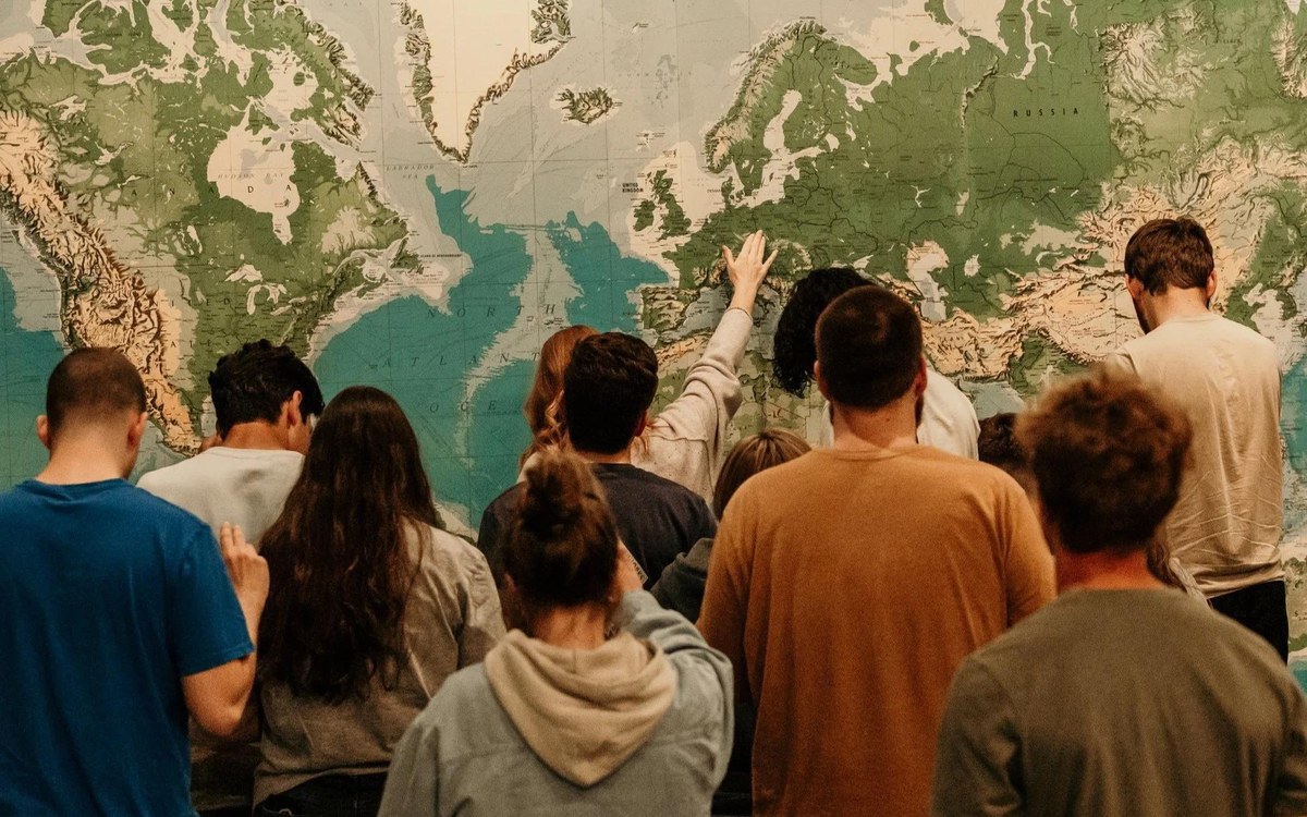 People and world map representing God at work across cultures and history